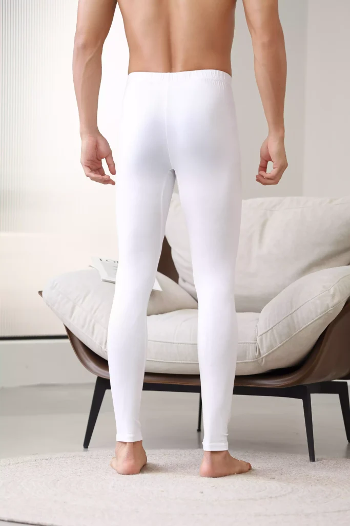 Back view of a man wearing white thermal leggings, showcasing the slim-fit design and comfortable elastic waistband.