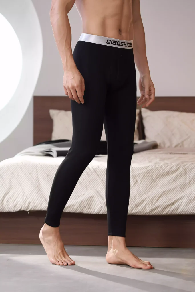 Side view of a man wearing black compression leggings, showcasing a sleek and comfortable fit.