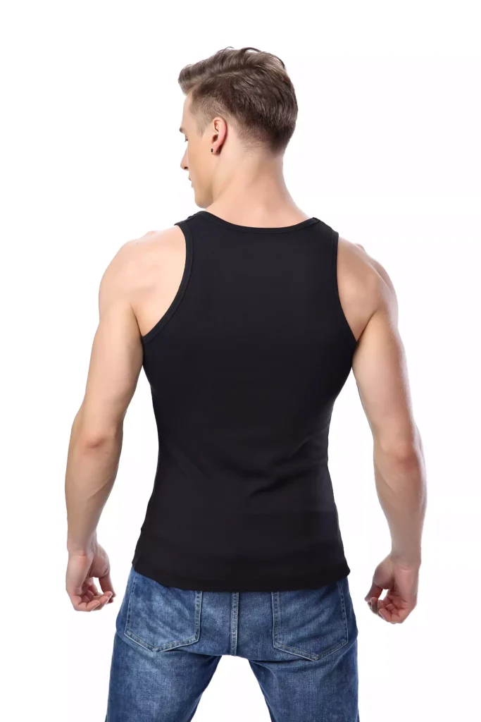 A male model seen from the back, wearing a fitted black cotton tank top and blue jeans, showing the garment's cut and fit.