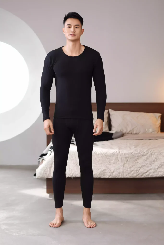 Front view of a man wearing a black thermal underwear set, demonstrating a clean and tailored fit.