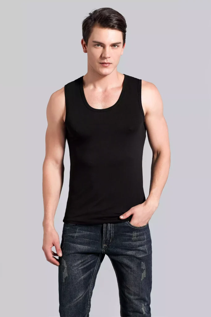 Front view of a man wearing a black tank top undershirt, demonstrating the slim-fit design and high-quality fabric against a grey studio background.