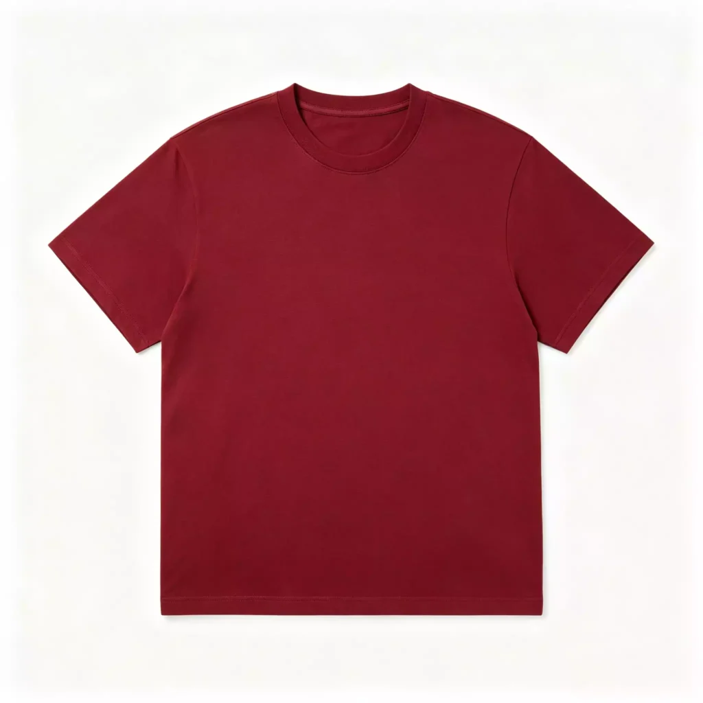 Flat lay of a burgundy men's crew-neck T-shirt on a clean white background, showcasing its classic cut, short sleeves, and smooth fabric texture.