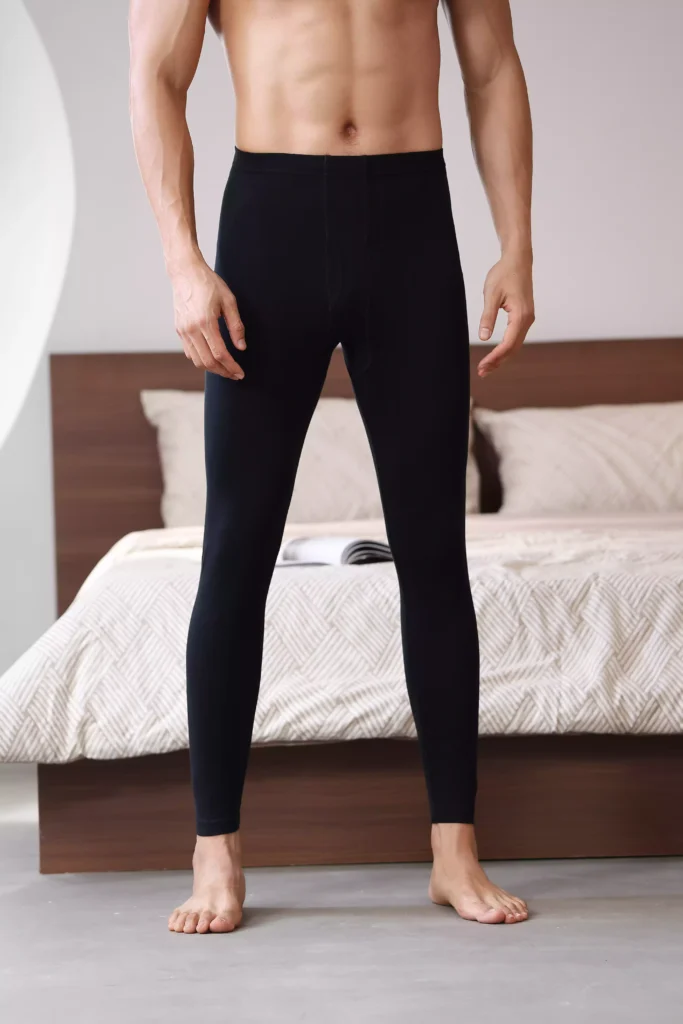 Front view of a man wearing fitted black thermal leggings, highlighting the seamless waistband and comfortable, body-contouring fit.