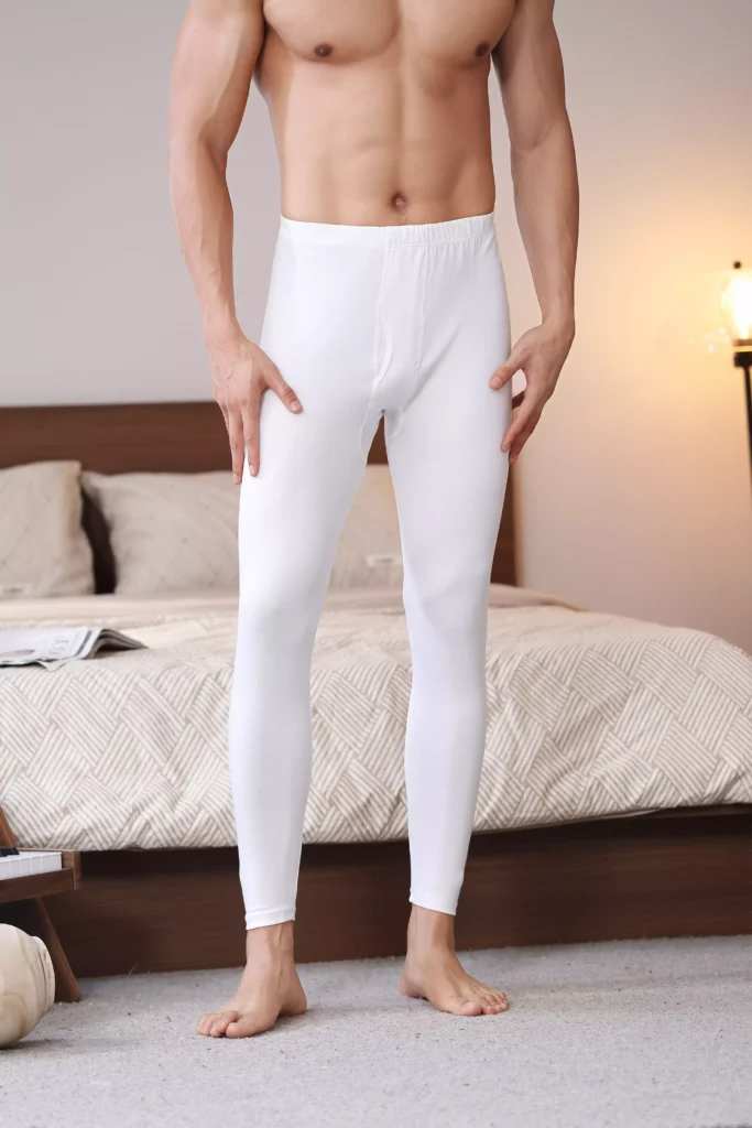 Front view of a man wearing fitted white thermal leggings, showcasing the seamless fit and comfortable fabric for winter layering.