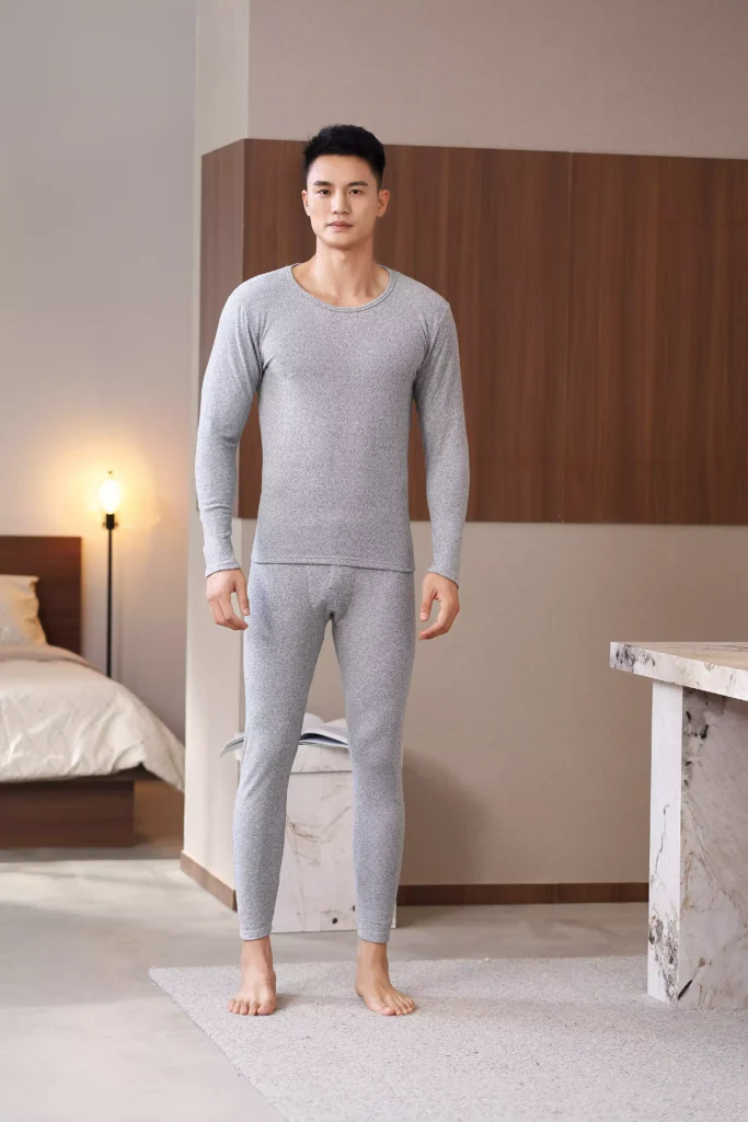 Front view of a man wearing a grey thermal underwear set, showcasing a clean, modern fit.