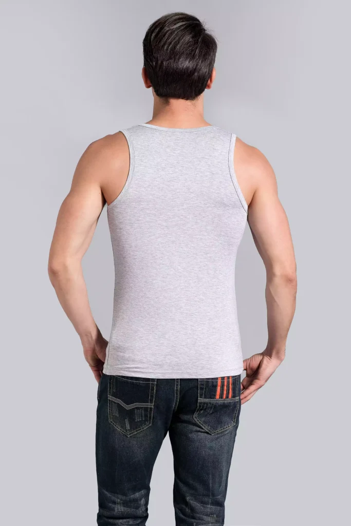 Back view of a man wearing a grey tank top undershirt, showcasing the sleek, slim-fit design and comfortable cut against a grey studio background.