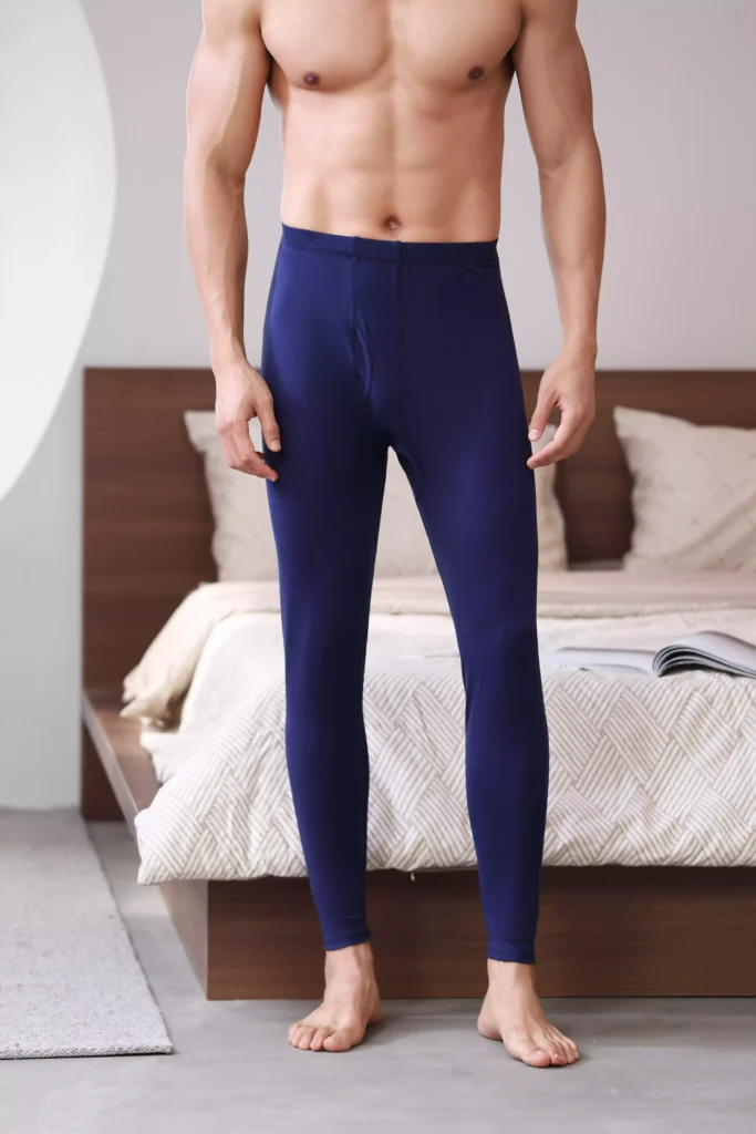 Front view of a man wearing navy blue thermal leggings, showcasing a comfortable and form-fitting design.