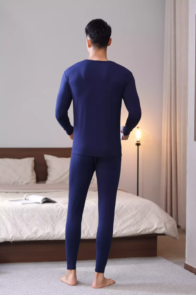 Back view of a man wearing a navy blue thermal underwear set, demonstrating the sleek, slim-fit design and comfortable cut.