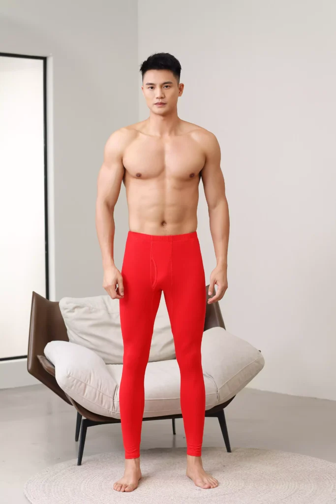 Front view of a man wearing bold red thermal leggings, perfect for festive occasions or as a high-visibility base layer.