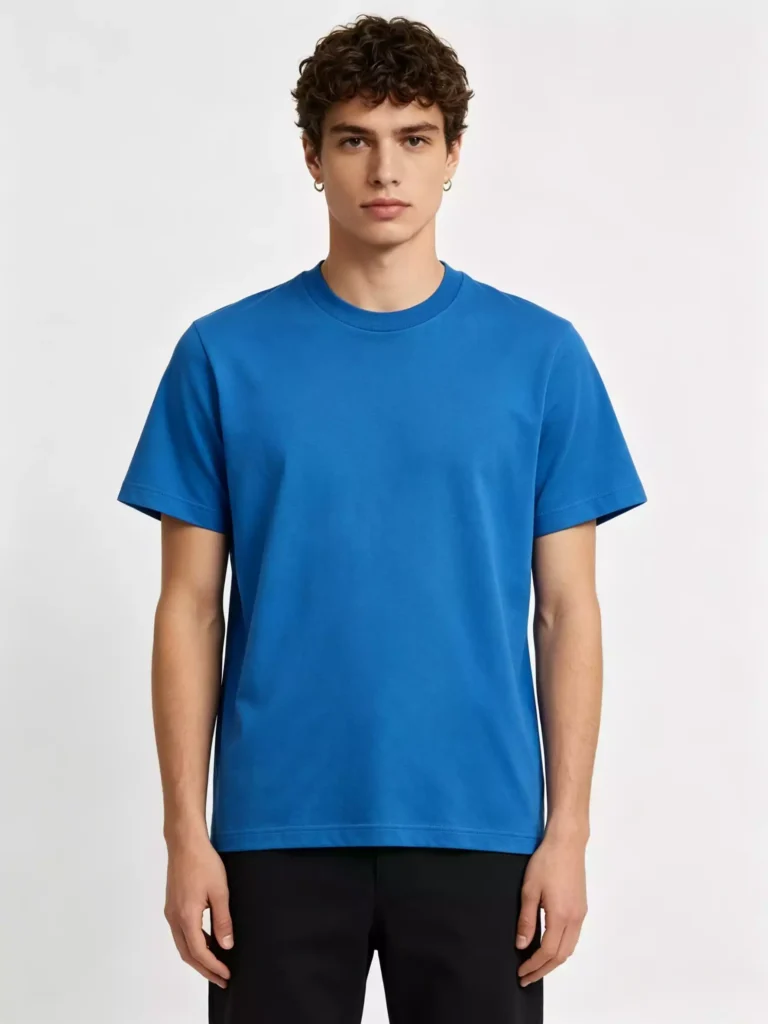 Front view of a male model wearing a vibrant royal blue crew-neck T-shirt, highlighting the clean fit and premium cotton fabric against a neutral studio background.