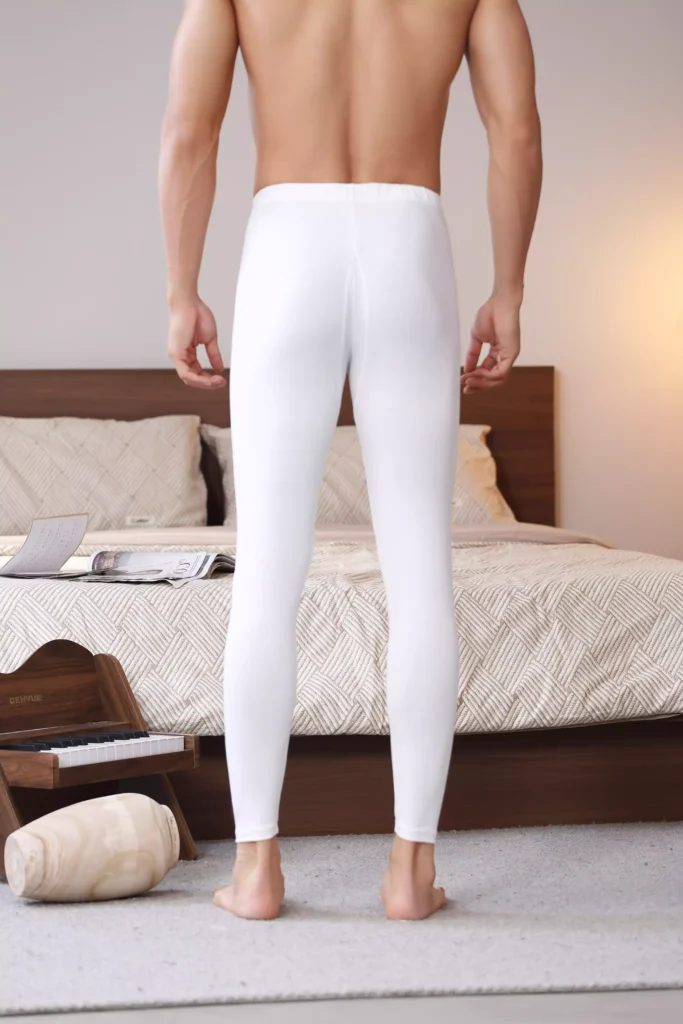 Rear view of a man wearing white thermal leggings, featuring a sleek, minimalist design and comfortable, form-fitting fabric for winter layering.