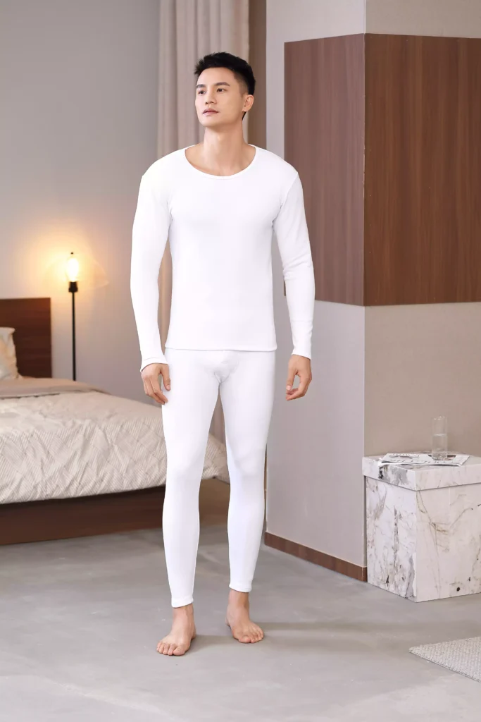 Front view of a man wearing a white thermal underwear set, demonstrating a clean, tailored fit.