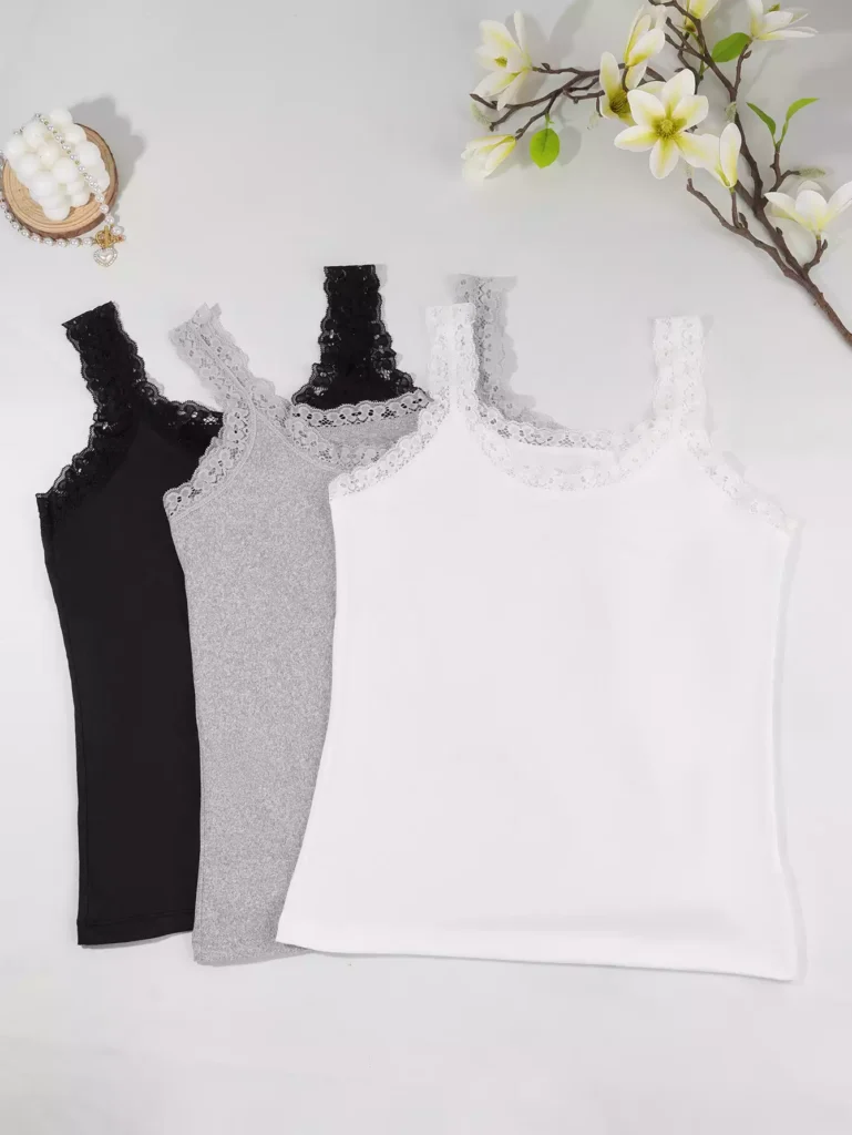 A set of three women's camisoles in black, grey, and white, featuring delicate lace trim detail, displayed on a flat surface